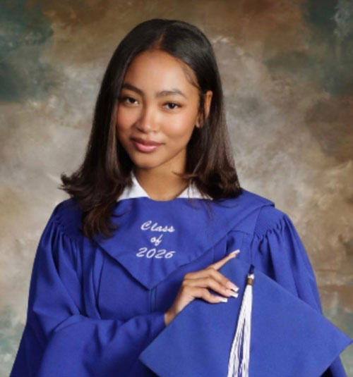 Grace-Trinidad | NJ Sharing Network Graduate woman in a blue cap-and-gown with tassel, posing for a class of 2026 portrait.
